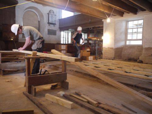 George and Christoph laying the timber floor  framework in the East Church, Cromarty